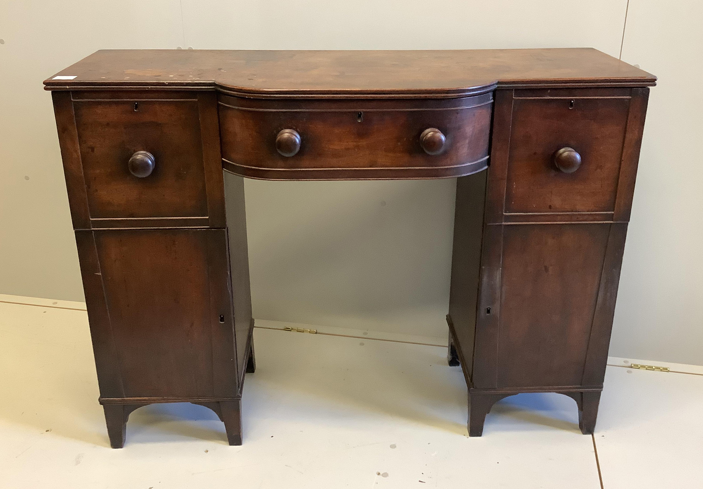 A Regency mahogany bowfront pedestal sideboard, width 126cm, depth 47cm, height 93cm